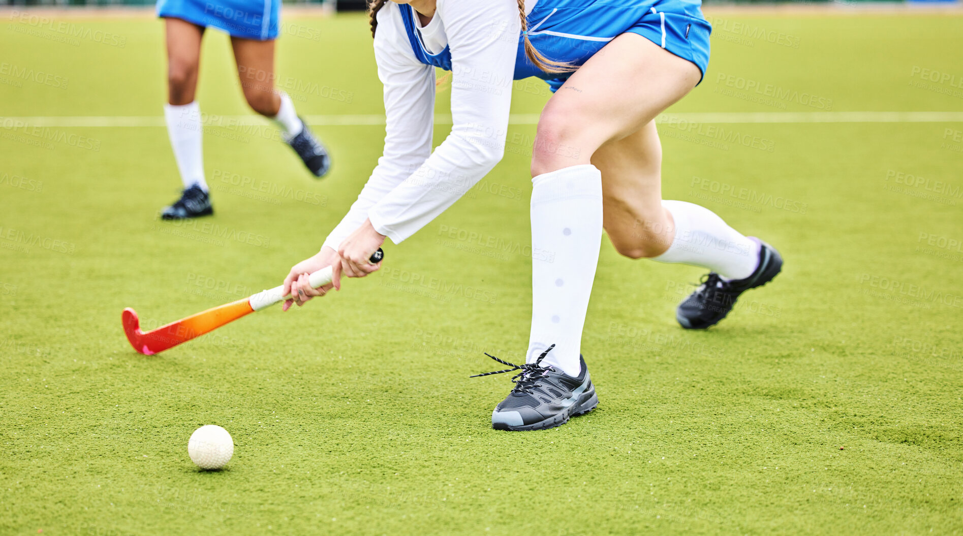 Buy stock photo Hockey, closeup and female athlete playing a game, match or tournament on an outdoor field. Fitness, sports and young woman training or practicing a defence strategy with a stick and ball at stadium.