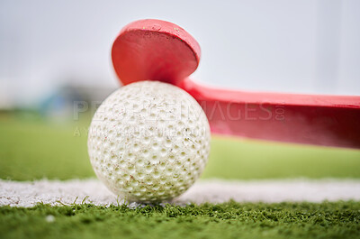 Buy stock photo Closeup, grass and a stick and ball for hockey, sports and training on a field for a game. Fitness, exercise and gear for a match, workout or competition on a turf or ground of a park for cardio
