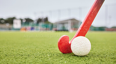 Buy stock photo Field, sports and a ball and a stick for hockey, fitness and training in the morning. Closeup, ground and gear or equipment for a competition, game or tournament at a stadium or turf on bokeh