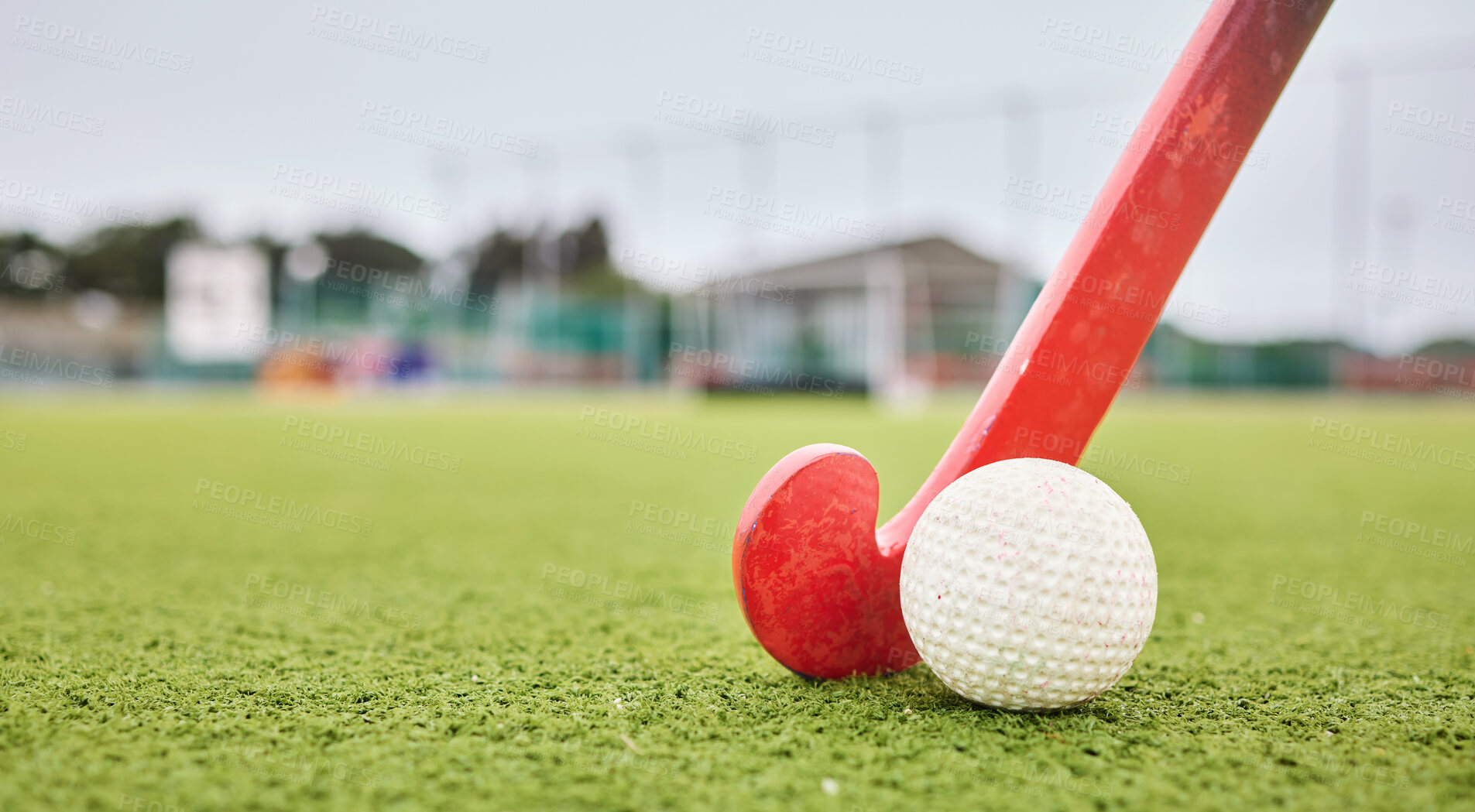 Buy stock photo Field, sports and a ball and a stick for hockey, fitness and training in the morning. Closeup, ground and gear or equipment for a competition, game or tournament at a stadium or turf on bokeh