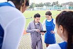 Game planning, soccer team and women with coach tablet for fitness, challenge and match play. Happy, smile and student athlete group with training, sport teamwork and motivation for field workout