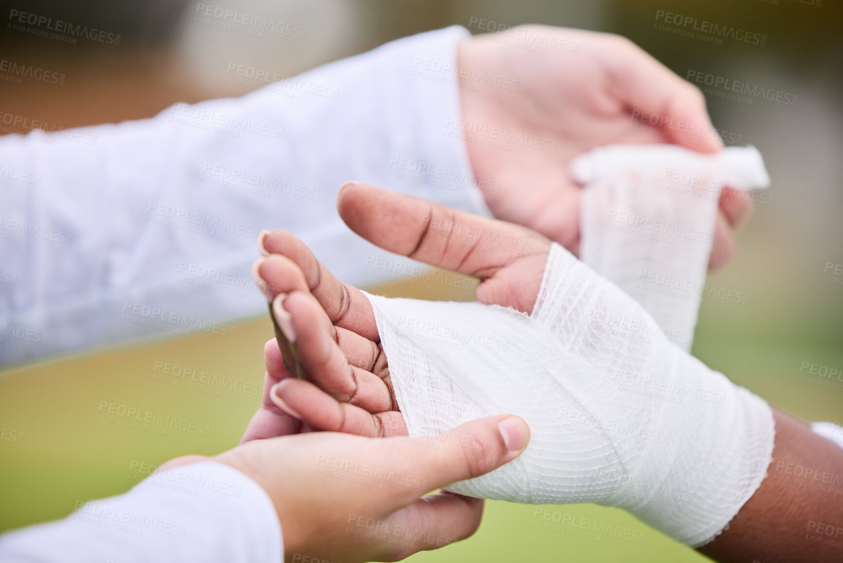 Buy stock photo Sports, bandage and person with hand injury support, first aid emergency and strain after game, competition or workout. Closeup, accident and medic helping athlete with gauze, wound or anatomy trauma