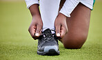 Lace shoes, sports person and field for training, performance or workout on grass turf. Closeup hands of athlete tie sneakers, footwear and feet to start exercise for game, fitness or contest on lawn