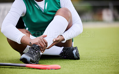 Buy stock photo Hockey, pain and leg injury by woman player on a field with problem, joint or muscle crisis in sport. Hand holding, ankle and athlete with emergency, inflammation or fitness accident from training
