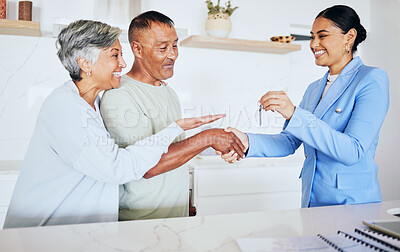Buy stock photo Happy senior couple, realtor and keys to new home in handshake for mortgage, property or investment. Excited elderly man and woman shaking hands for real estate retirement, house payment or purchase