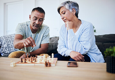 Buy stock photo Senior couple, chess match and home with thinking, strategy and mindset for brain power, relax and bonding. Elderly woman, man and sofa with board game, ideas and brainstorming for challenge in house