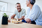 Senior couple, playing chess and happy for thinking, strategy or mindset with excited smile, relax or bonding. Elderly woman, man and sofa for board game, idea or moving for win, challenge and home