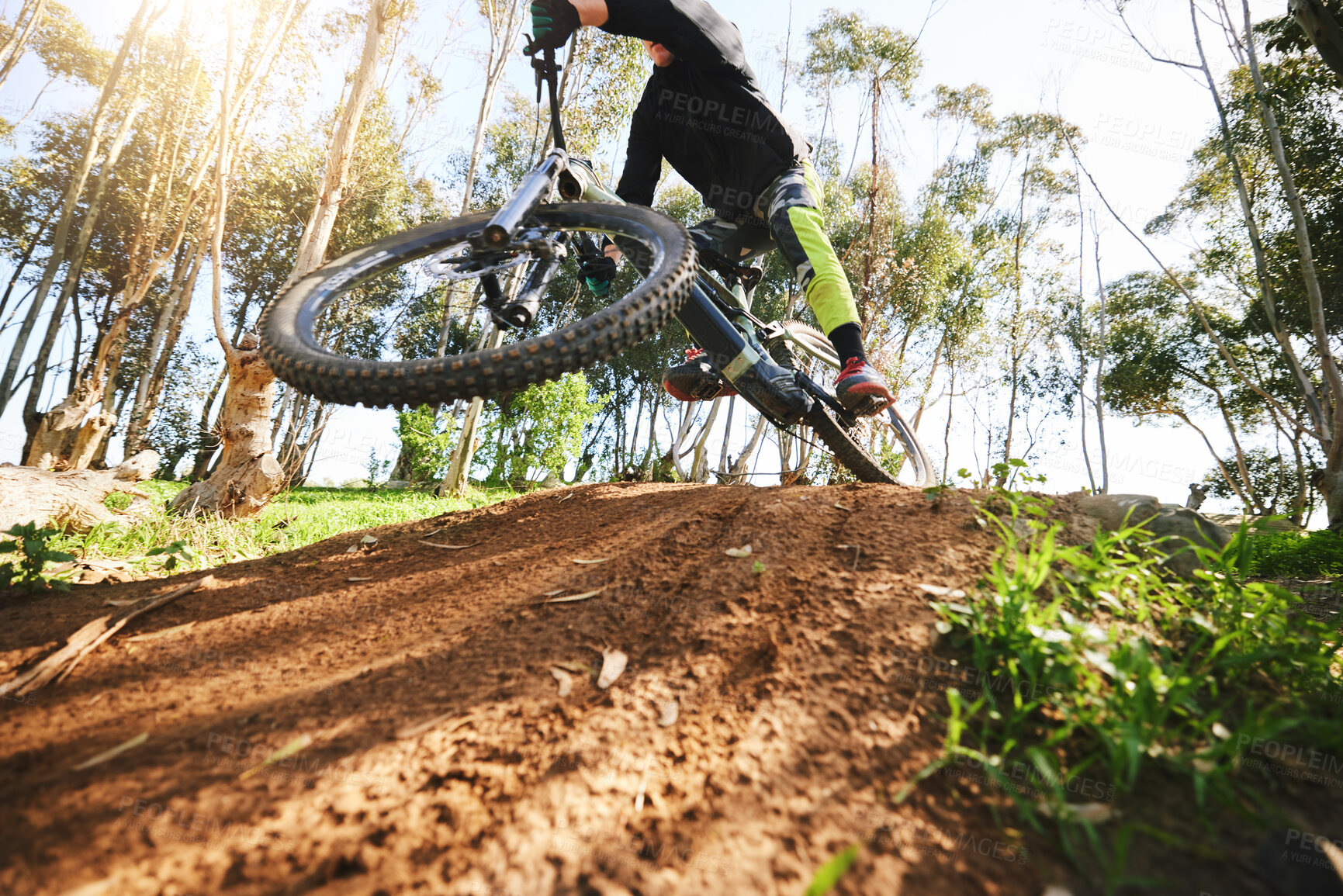 Buy stock photo Bike, jump and dirt with speed in low angle for sports, race and adventure in summer, woods or nature. Extreme cycling, person and outdoor for trail, competition or challenge for fitness in forest
