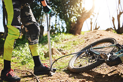 Sports, air and pump with person and mountain bike in nature for repair, cycling and maintenance. Inspection, cardio and fitness with closeup of cyclist in forest for challenge, journey and training