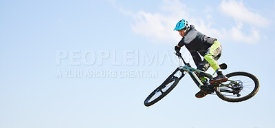 Mountain bike, man and jump in blue sky for competition, freedom or adventure on mockup space. Banner of athlete, sports and bicycle in air for action, cardio race and courage of stunt, speed or risk