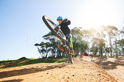 Buy stock photo Bicycle, wheelie and man with ramp, outdoor and speed for sport, race or adventure in summer, fitness or nature. Extreme cycling, person and jump for trail, exercise or challenge for workout in dirt