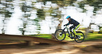 Bicycle, man and speed with motion blur in forest for sport, race or adventure in summer, woods or nature. Extreme fast cycling, person and action on trail, workout or challenge for fitness in nature