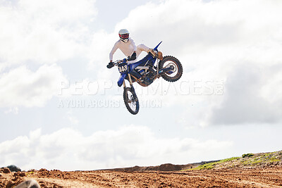 Sports, jump and man on motorcycle with freedom, energy and power stunt in the countryside for training challenge. Off road, air and male jumping with motorbike for speed, performance or Moto action