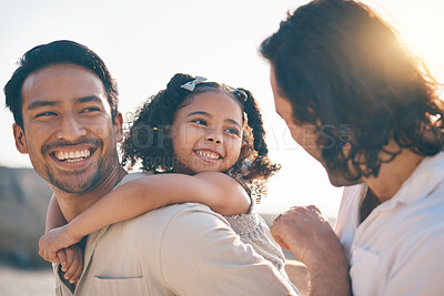 Buy stock photo Gay couple, piggyback and smile with family at beach for seaside holiday, support and travel. Summer, vacation and love with men and child in nature for lgbtq, happiness and bonding together