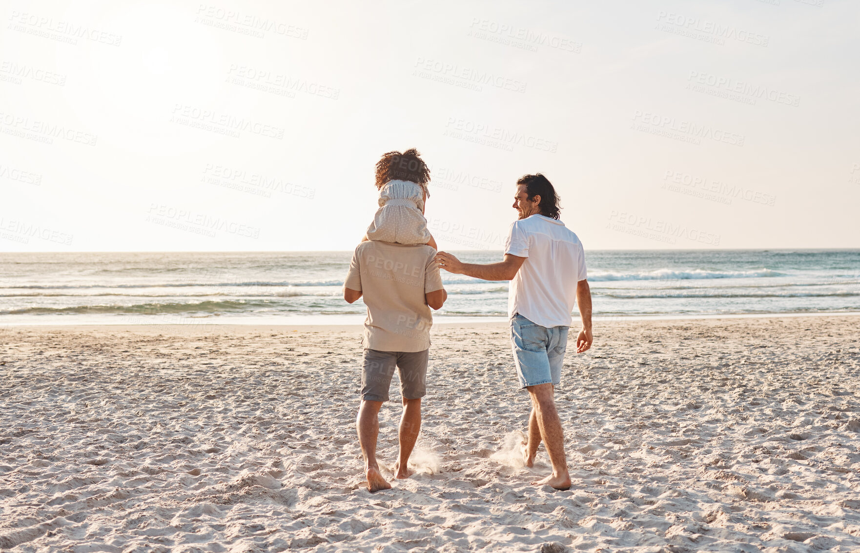 Buy stock photo Beach, LGBT and walking kid, family and enjoy freedom together on travel vacation, holiday or nature freedom. Love, back and gay couple, people or parents bonding with adoption child on shoulder