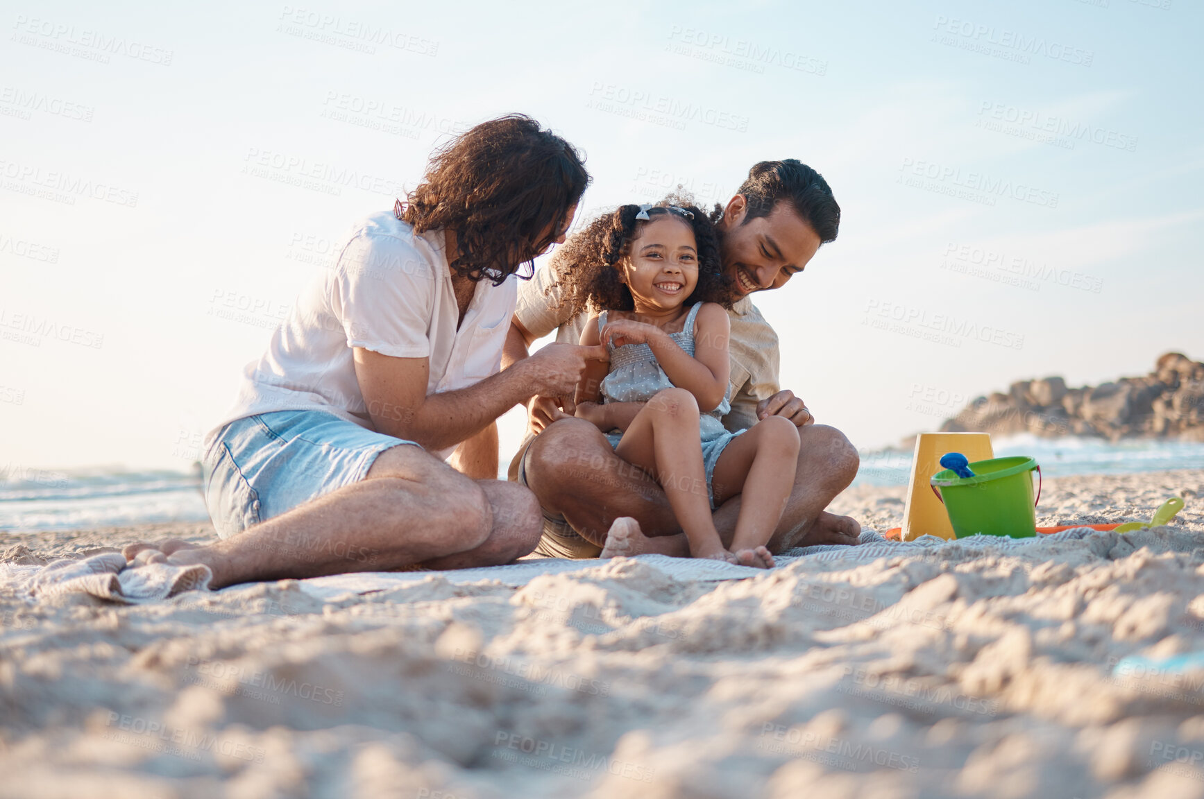 Buy stock photo Happy, playing and a lgbt family at the beach for summer relax, love and travel together. Smile, vacation and gay men with a girl kid at the ocean for a holiday, fun and laughing on the sand