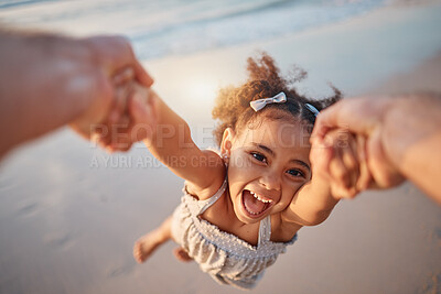 Buy stock photo Girl child, spin and pov by ocean, portrait and smile for game, holding hands or speed in summer. Young female kid, parent and swing in air, sand or happy for family bonding, love or care in sunshine