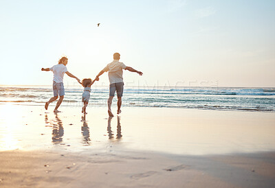 Buy stock photo Gay parents holding hands with girl at beach running in water on holiday, vacation and adventure. Lgbtq family, sunset and happy child with fathers by ocean for bonding, relaxing and fun outdoors