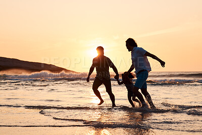 Buy stock photo Lgbt family on beach, men and child holding hands at sunset, running in waves and island holiday together. Love, happiness and sun, gay couple on tropical ocean vacation with daughter in silhouette.