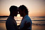 Sunset, embrace and gay men on beach, silhouette and love on summer vacation together in Thailand. Sunshine, ocean and romance, lgbt couple hug in nature and fun holiday with pride, sea and waves.