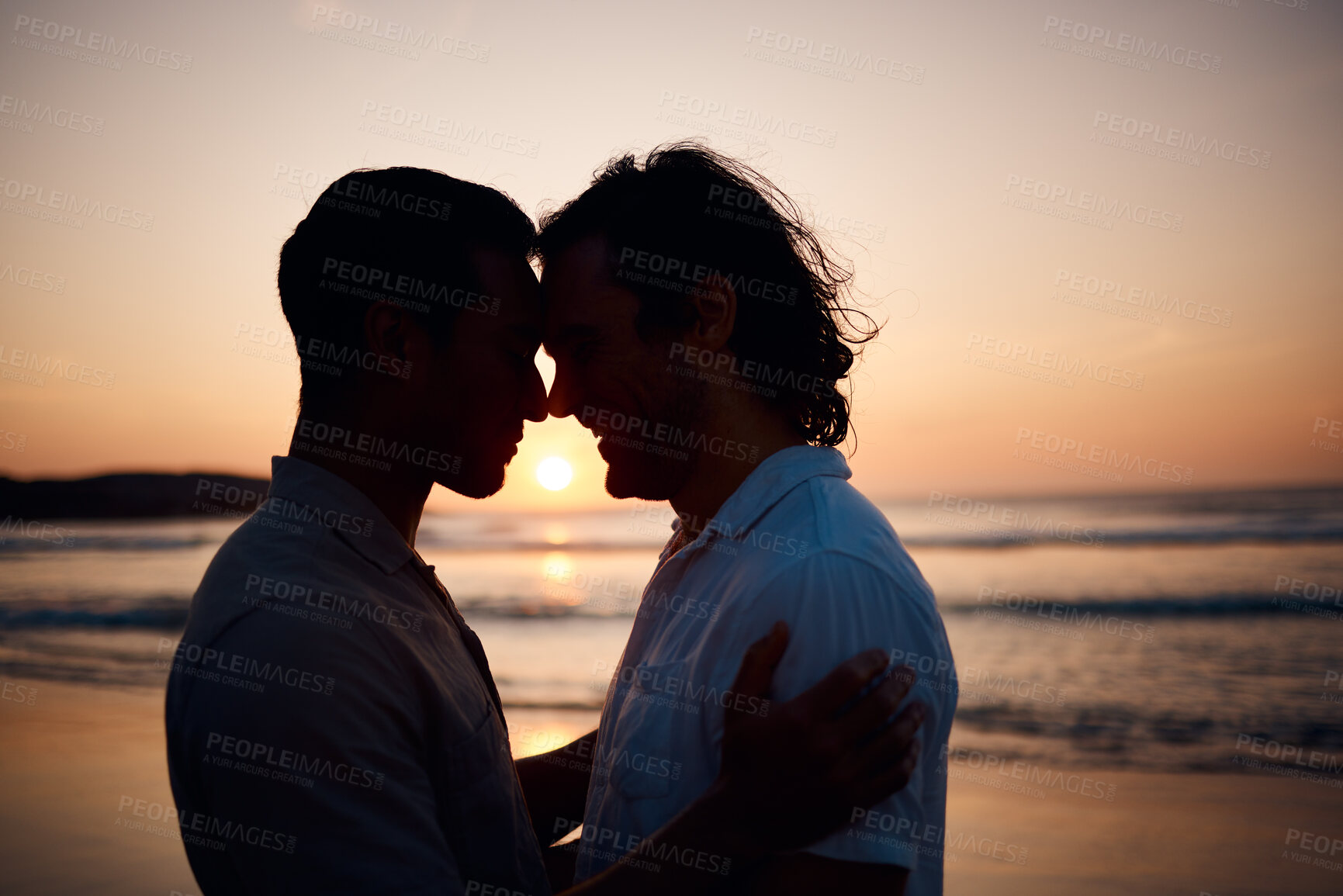 Buy stock photo Sunset, embrace and gay men on beach, silhouette and love on summer vacation together in Thailand. Sunshine, ocean and romance, lgbt couple hug in nature and fun holiday with pride, sea and waves.