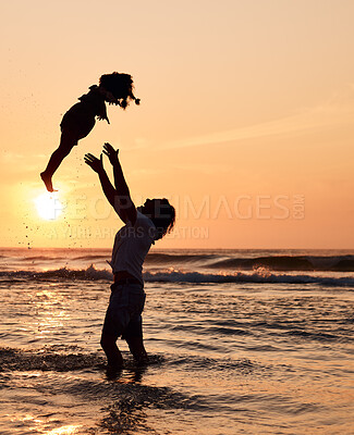 Buy stock photo Father, throw and child in air at beach, sunset and waves in the ocean for happiness, fun and support on adventure. Parent, kid and silhouette of dad in the sea with love to play a game with girl