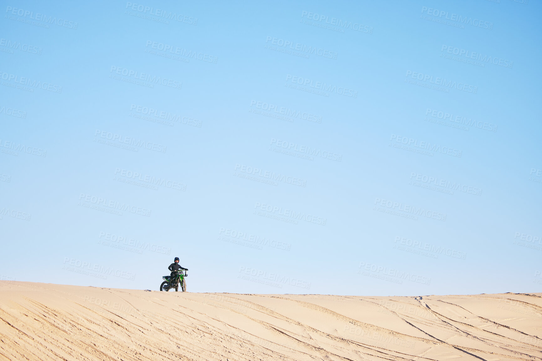 Buy stock photo Motorcycle race, desert and sand with space, blue sky background and outdoor for off road challenge in summer. Motorbike, person and dirt trail for performance, power and fast adventure for mockup