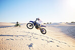 Motorcycle, desert race and jump in air for competition, stunt and outdoor for performance, goal and speed. Motorbike athlete, dunes and ramp in nature, sand and together for training in mockup space