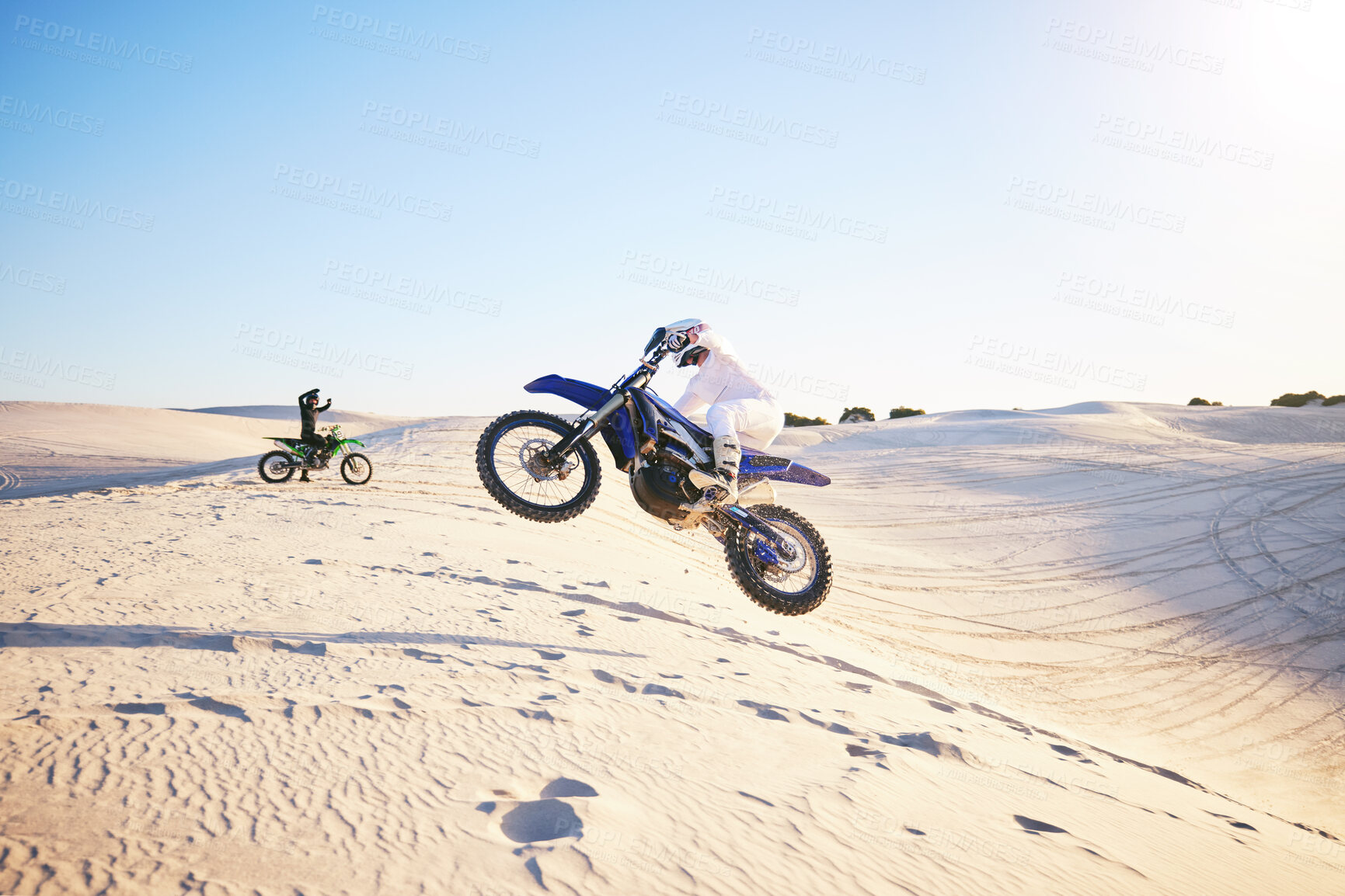 Buy stock photo Motorcycle, desert race and jump in air for competition, stunt and outdoor for performance, goal and speed. Motorbike athlete, dunes and ramp in nature, sand and together for training in mockup space