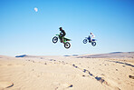Motorbike, desert race and jump in air for competition, stunt and outdoor for performance, goal and speed. Motorcycle athlete, dunes and ramp in nature, fast or together for contest by sky background