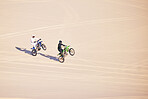 Motorcycle, sand and sports with people in the desert for adrenaline, adventure or training in nature. Bike, summer and freedom with friends outdoor together to wheelie while riding on mockup space