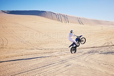 Buy stock photo Bike, sports and space with a man in the desert for adrenaline, adventure or training in nature. Moto, fitness and freedom with an athlete riding a motorcycle for energy or balance on sand in Dubai