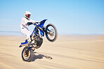 Bike, sand and motion blur with a man in the desert for adrenaline, adventure or training in nature. Energy, speed and balance with a male sports athlete riding a motorcycle in a remote location 