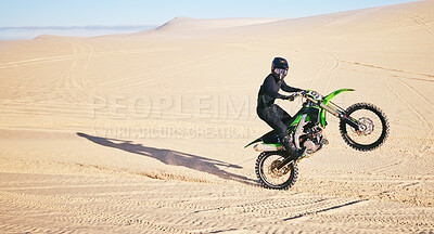 Buy stock photo Motorcycle, sand and space with a man in the desert for adrenaline, adventure or training in nature. Energy, summer and balance with an athlete riding a bike for sports training in a remote location