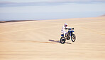 Race, motorcycle and person in desert, action and extreme sport with speed, riding outdoor and mockup space. Adventure, fitness and training, motorbike exercise and freedom, challenge and performance