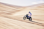 Motorcycle, sports and space with a man in the desert for fitness or an adrenaline hobby for freedom. Bike, training and summer with a male athlete riding a vehicle in Dubai for energy or balance
