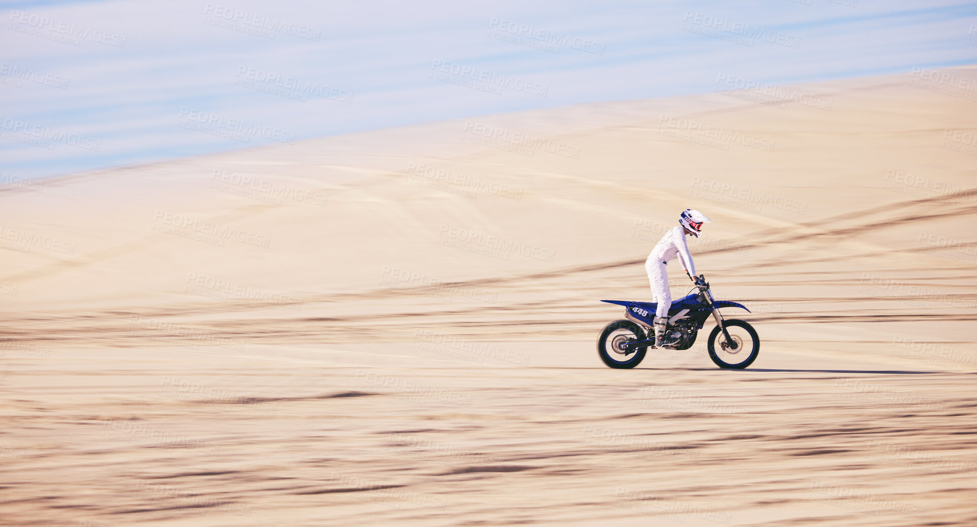 Buy stock photo Bike, sports and space with a man in the desert for fitness or an adrenaline hobby for freedom. Motorcycle, training and summer with a male athlete riding a vehicle in Dubai for energy or balance