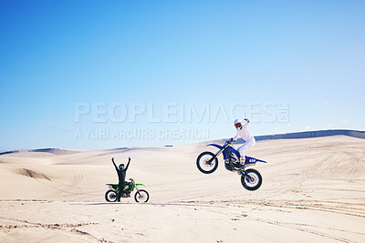 Buy stock photo Bike, winner and motivation with people in the desert for fitness or adrenaline while training. Motorcycle, support and celebration with athlete friends cheering a jump in Dubai for energy or freedom