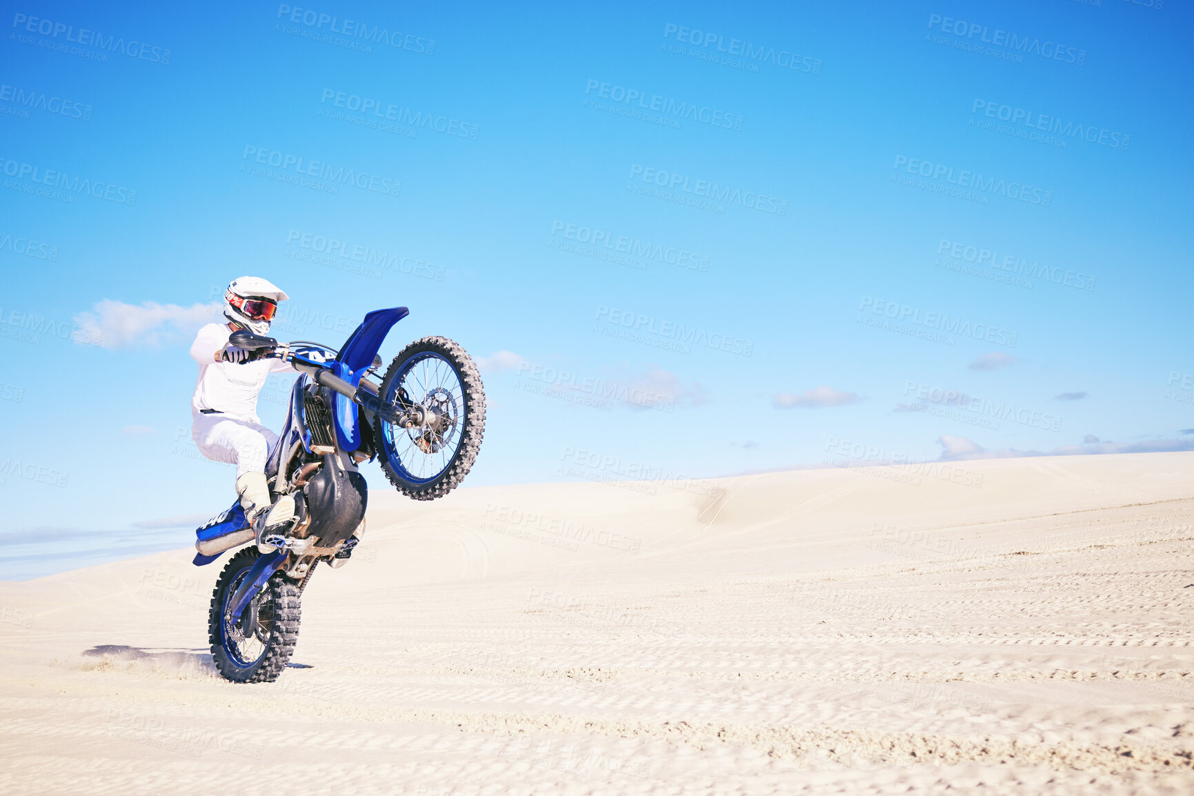 Buy stock photo Bike, mockup and balance with a man in a desert for fitness or an adrenaline hobby on space. Motorcycle, skill and summer with a male sports athlete riding a vehicle in Dubai for freedom or energy