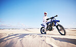 Sand, motor sports and man with motorbike for adrenaline, adventure and freedom in desert. Action, extreme challenge and male person on bike on dunes for training, exercise and race or competition