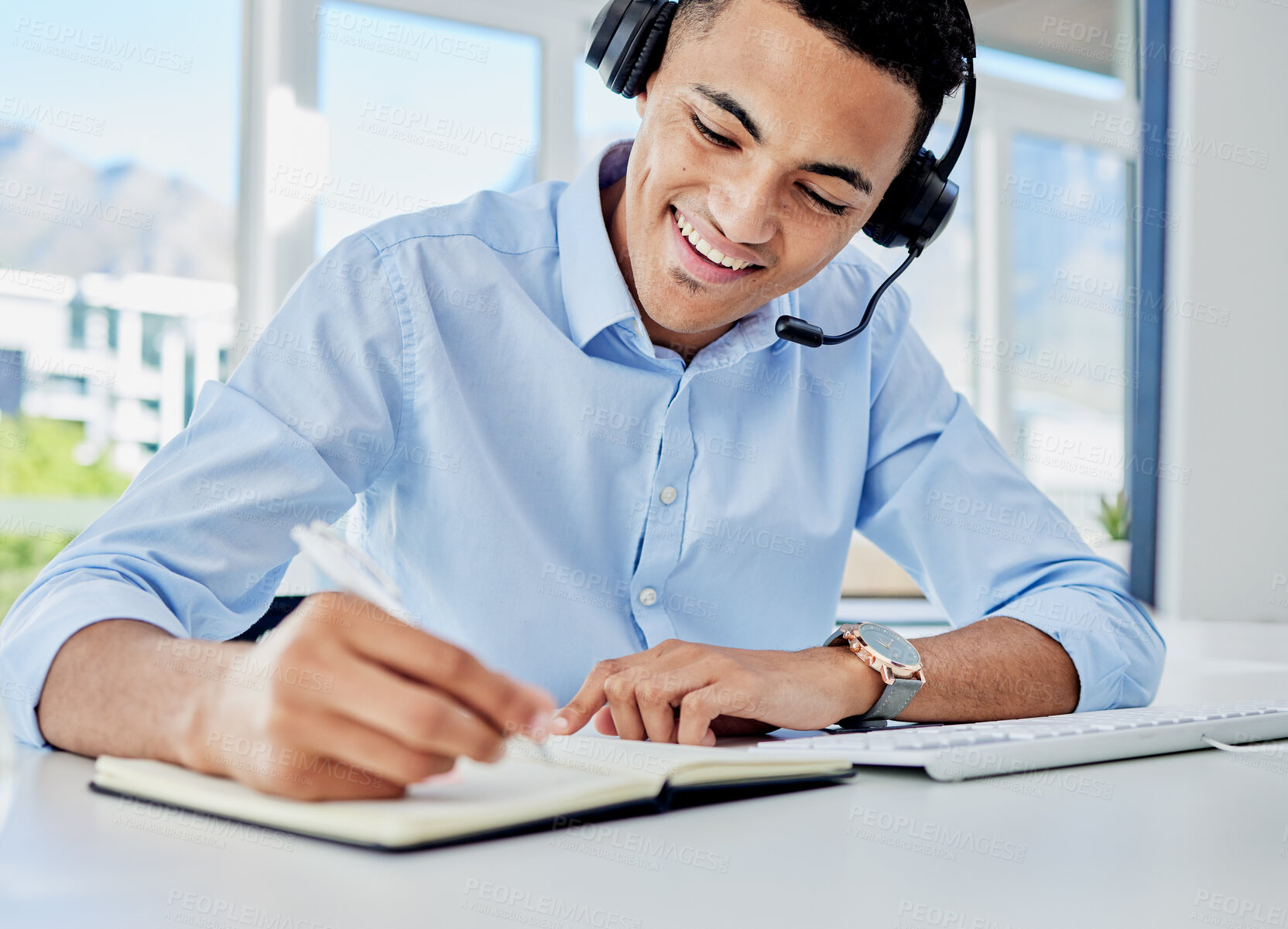 Buy stock photo Smile, call center and a man with a notebook for planning, telemarketing agenda or consulting notes. Happy, office and a customer service employee writing a strategy for online support or advice