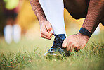 Hands, rugby athlete and tie shoes to start workout, exercise or fitness. Sports, player and man tying boots in training preparation, game or competition for healthy body or wellness on field outdoor