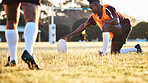 Rugby ball, kick and sport game with holding support, exercise and competition with athlete training. Field, black man and target practice on grass with fitness and team workout outdoor for teamwork