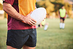 Rugby, man and hands with ball for sports games, competition and contest on field. Closeup of athlete, team player and training at stadium for fitness, exercise and performance of challenge outdoor 