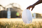 Sports, rugby and hand of person with ball ready for game, competition and tournament outdoors. Fitness, mockup and closeup of player on grass field for exercise, training and workout in practice