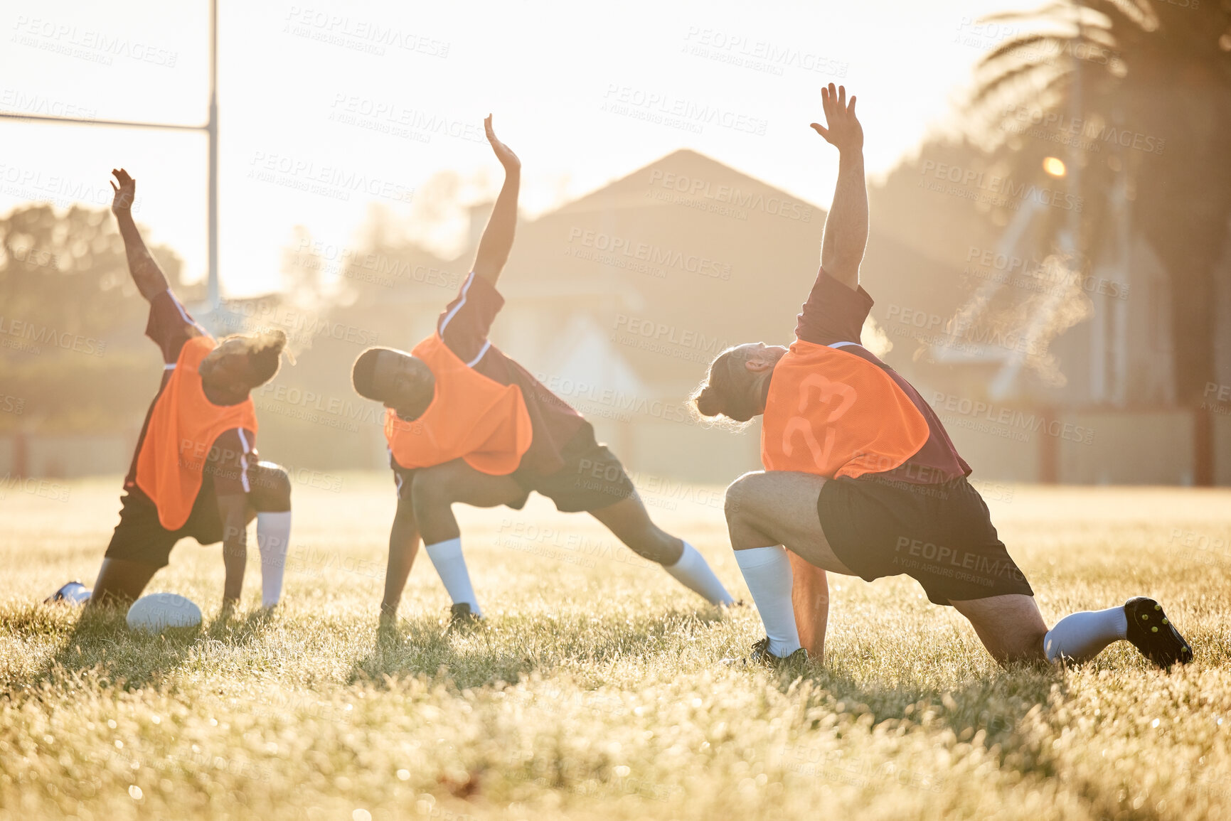 Buy stock photo Rugby, club and team stretching at training for match or competition in the morning doing warm up exercise on grass. Wellness, teamwork and group of players workout together in professional sports