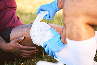 Buy stock photo Bandage, knee pain and injury, medic help athlete and sports accident on field with health and wellness. People outdoor, paramedic dressing wound and medical care with inflammation and fracture