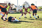 Rugby, sports and running with a team on a field together for a game or match in preparation of a competition. Fitness, training and teamwork with a group of men outdoor on grass for club practice