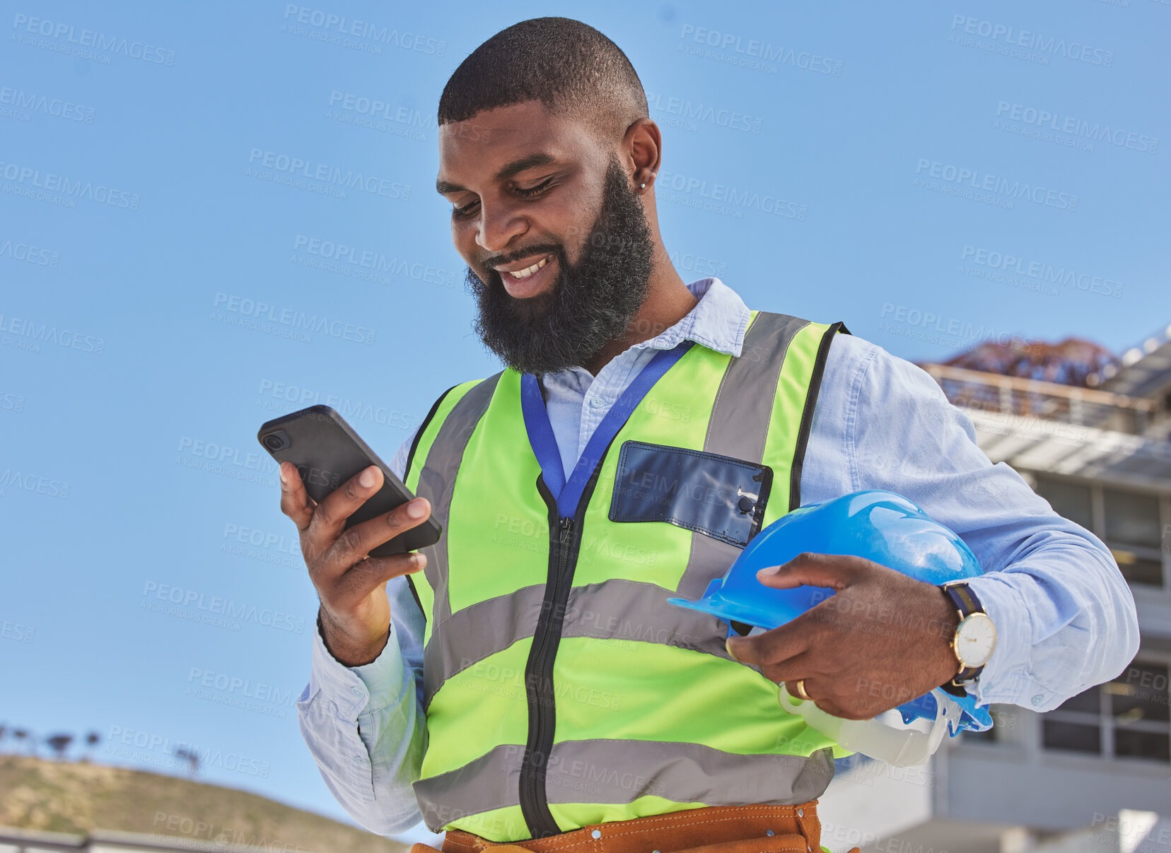 Buy stock photo Black man, online or architect with phone on construction site for building update, social media or networking. Smile, news or happy African engineer texting to chat on digital mobile app on Internet