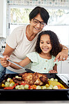 Kitchen, health and a grandmother cooking with her grandchild in their home together for thanksgiving. Children, love and a roast with a senior woman preparing a meal with a girl for food nutrition